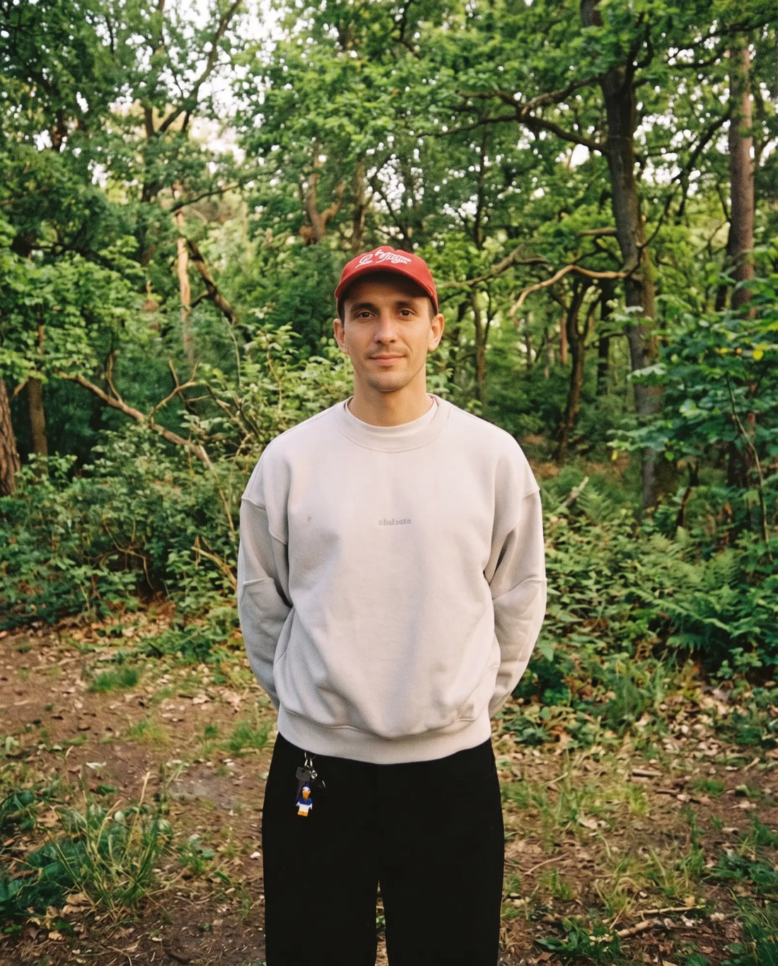 William, founder of Capri Studios, standing in a forest.