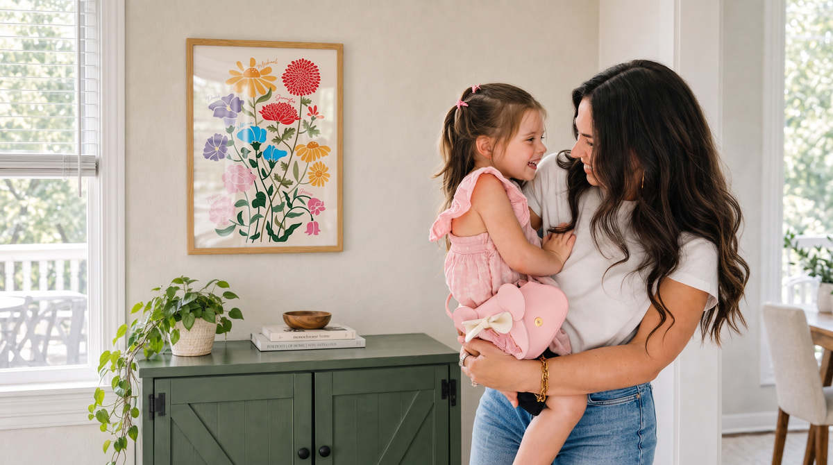 Mother and daughter beside Family Garden artwork in a wood frame with glass